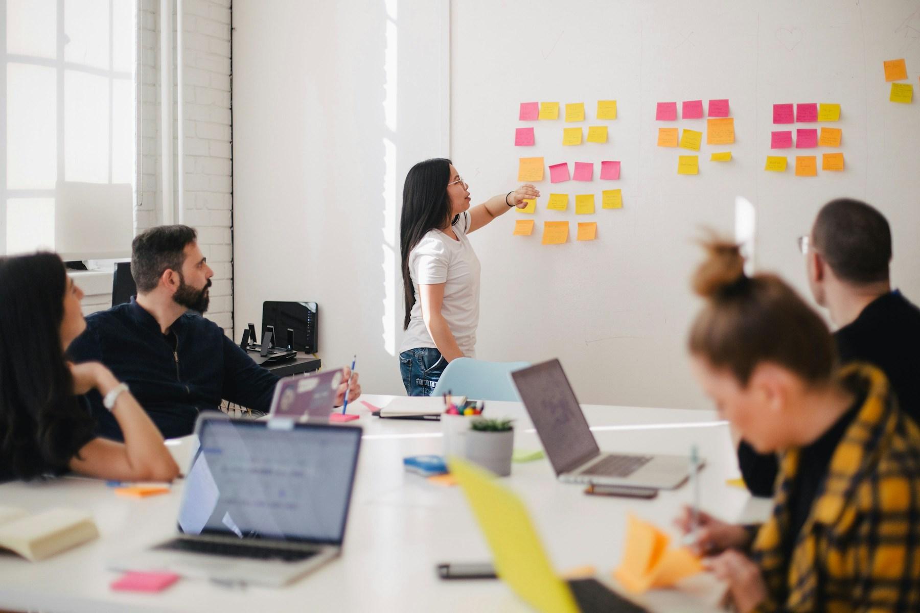 A team planning product work with notes and laptops